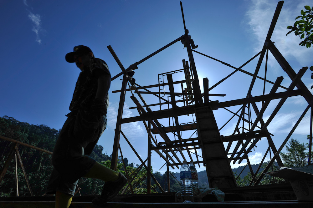 Silhouette of a worker walking away from the Spyder Hill construction site at Pantai Hill Orchard Resort.